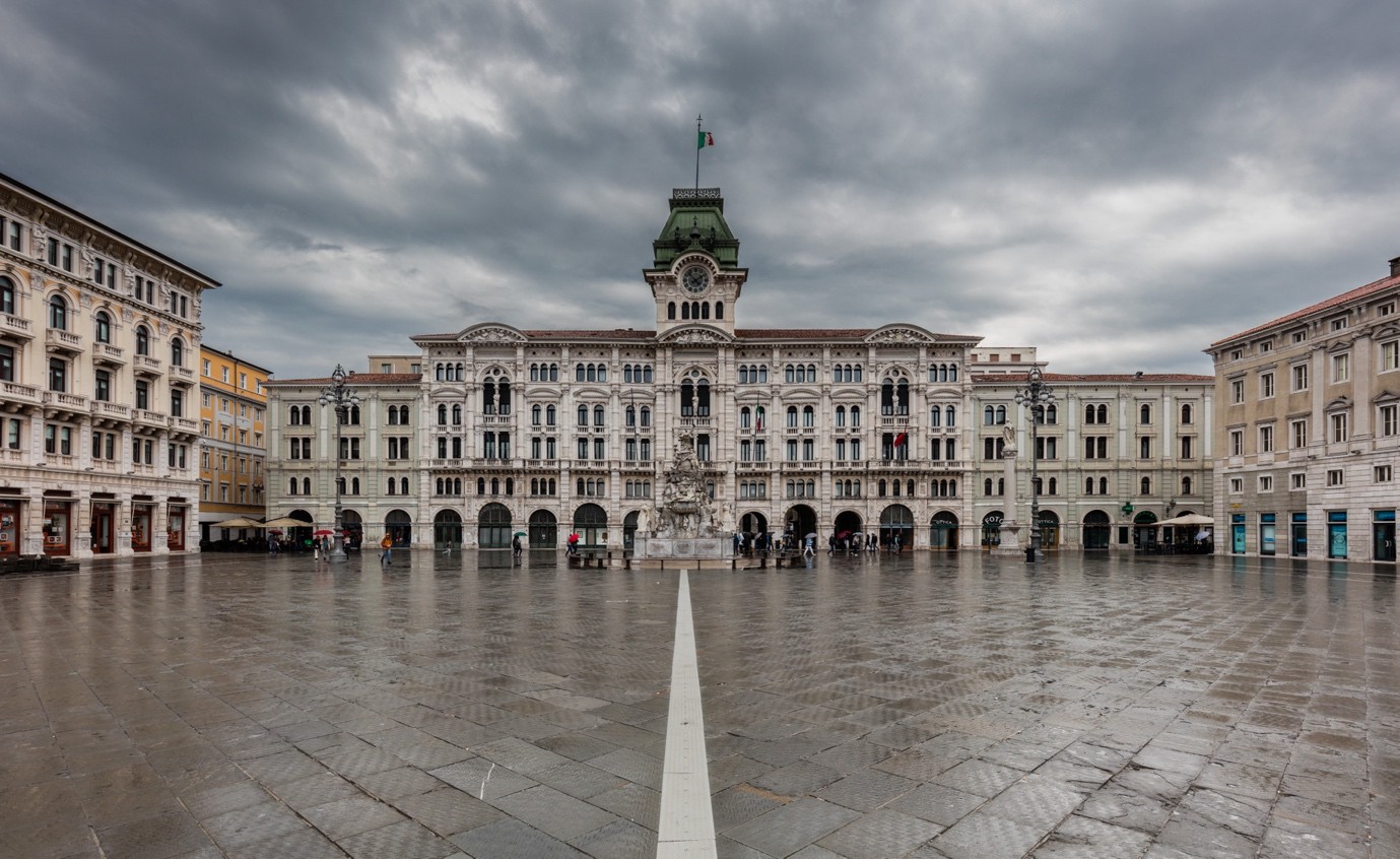 Piazza Unita d'Italia in Trieste under a stormy sky, open to the sea on one side