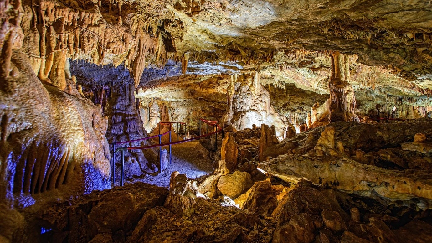 Walkways and coloured lighting inside a cave chamber in Istria