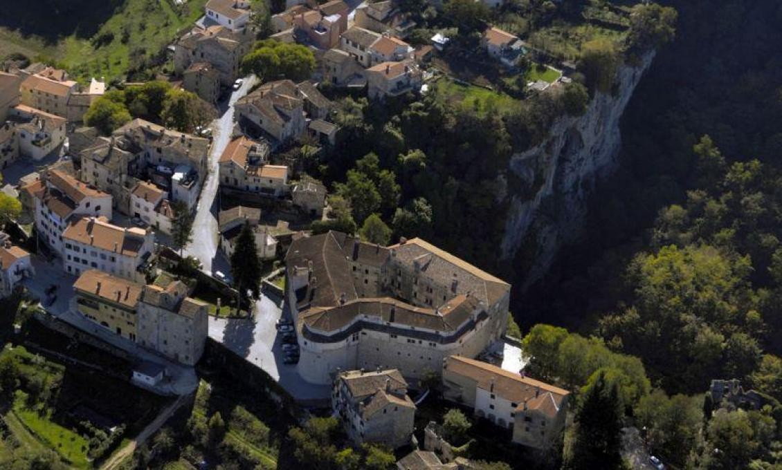Pazin Castle seen from the air, standing on the cliff edge above the Pazin abyss
